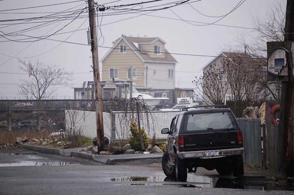 An SUV sits on a street dominated by above-ground
wiring.