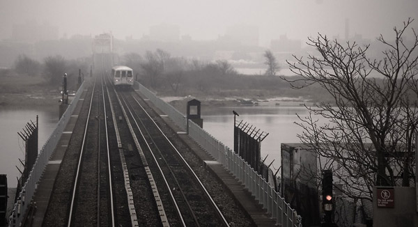An 'A' train heads off on a bridge to the Rockaways.