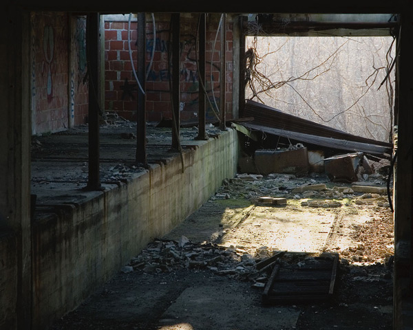 A dark room filled with debris, and a channel of light
at the end.