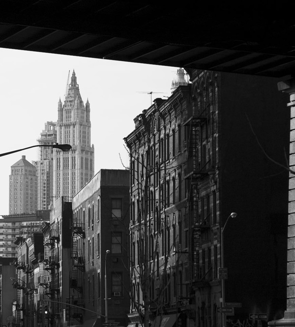 One of the first skyscrapers towers over
tenements.