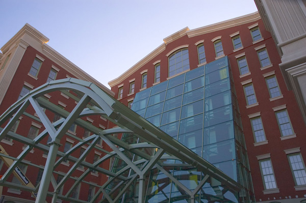 A large old brick building has a new shiny glass
entrance.