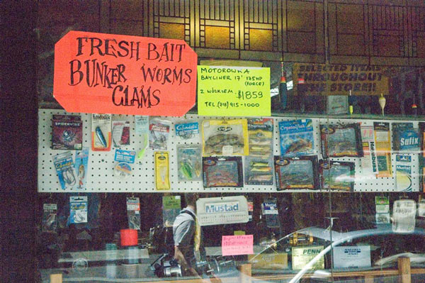 A tackle shop advertises assorted varieties of fresh bait.
