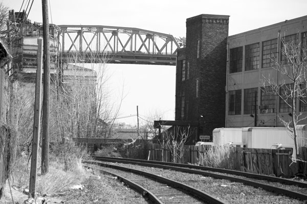 Railroad tracks run past warehouses and off to the
distance.