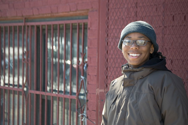 A person in a knit cap gives me a big broad
smile.