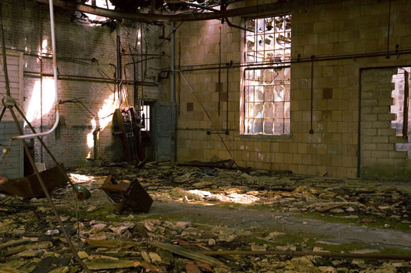 An old airplane hangar shows years worth of neglect.