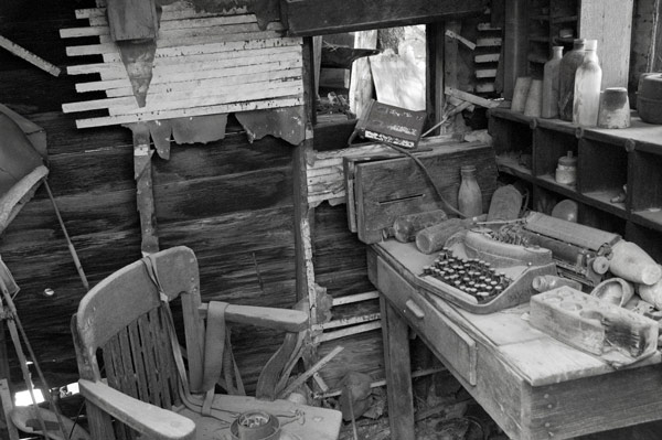 Dust covers an old desk chair, a manual typewriter, and old
junk.