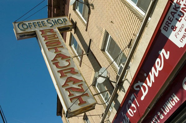 A vertical sign on a building's front proclaims 'Coffee
Shop.'