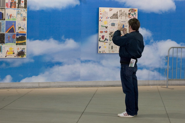 A tourist photographs children's artwork at Ground
Zero.