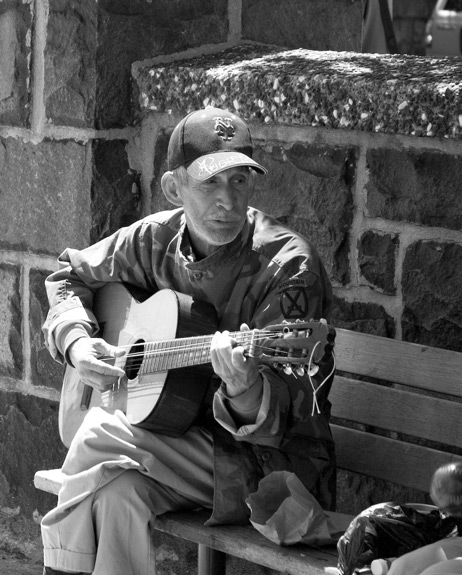 A guitarist trading songs with friends.