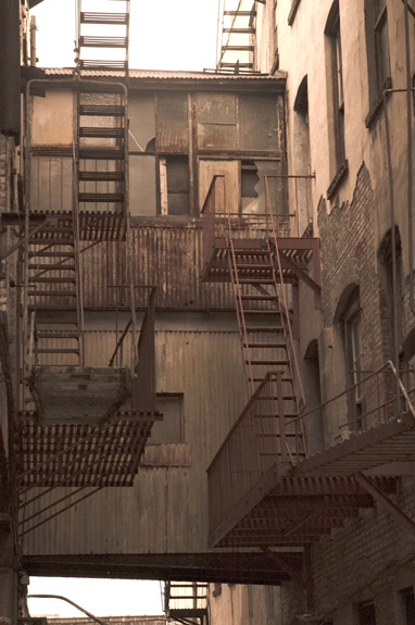 Fire escapes on opposite buildings unite with a building
bridge.