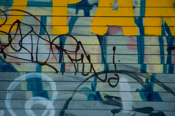 A rolltop door shows several generations of paint.