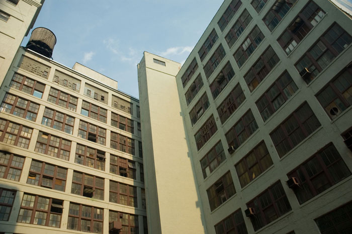 A warehouse towers above your view, with a water tank on
top.