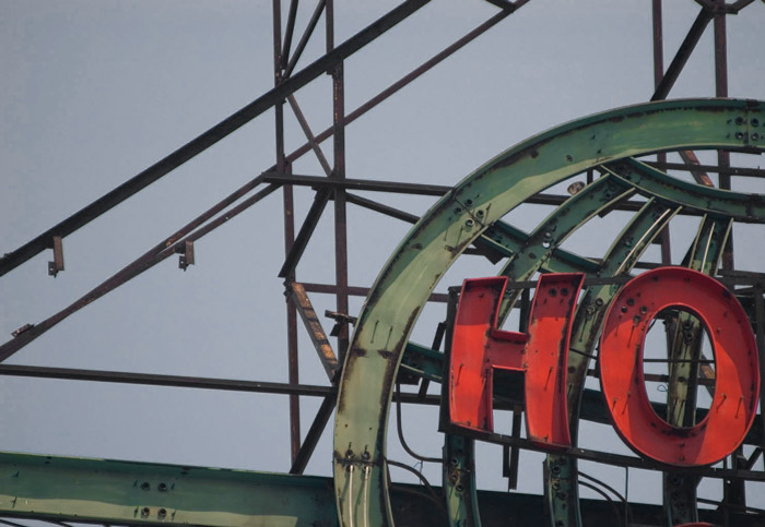 Red letters against the green structure of old neon.