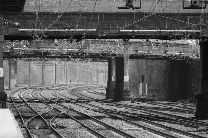 Pillars, an overpass, and train tracks curve away in the
distance.