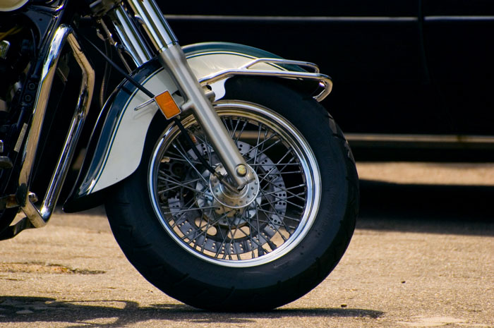 Chrome galore, on the front wheel of a motorcycle.