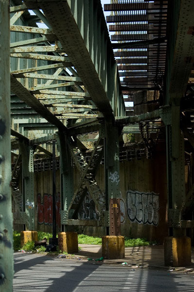 Sunlight and shadows from an overhead train track.