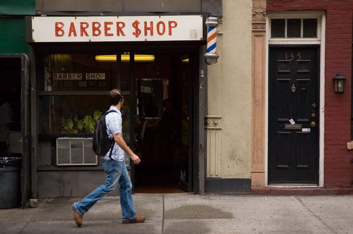 A barber shop sign uses a dollar sign for the 's' in 'shop.'