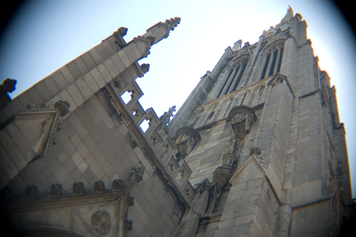 A church's spires are seen through a fish-eye lens.