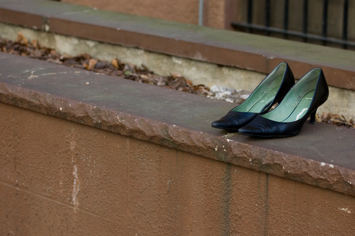 A pair of navy blue high heeled shoes has been set out for someone to take.