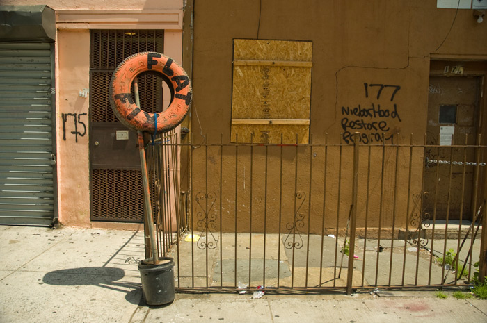 A tire-repairing service uses a painted red tire, with the words 'Flat Fix' to advertise its service.