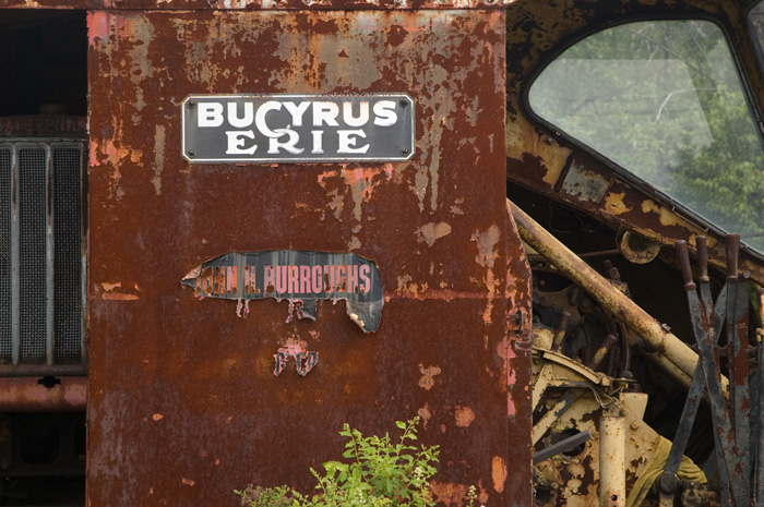 The picture shows the rusted outer walls of the cab of a steam shovel.