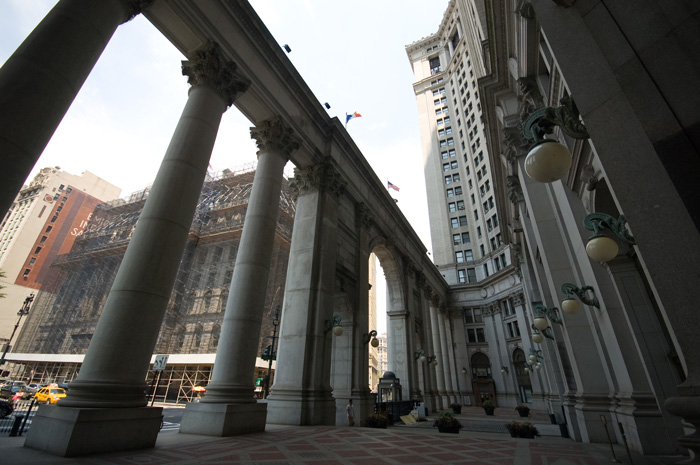 A colonade points to one side of a u-shaped building.