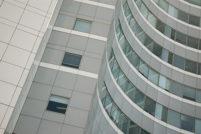 An office tower's concave section creates the optical illusion that it's a separate office tower.