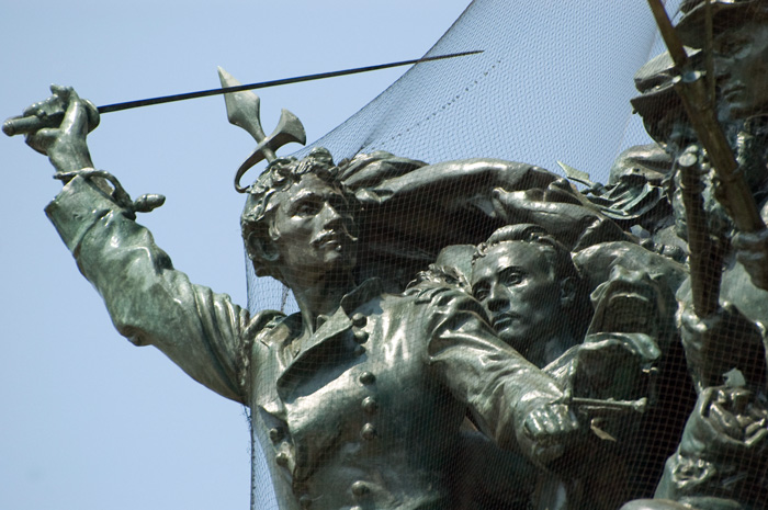 Union soldiers charge, as part of a large memorial sculpture.