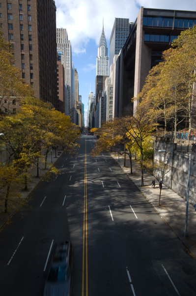 A Manhattan street stretches from one side of the island to the other, with the Chrysler Building and New Jersey visible.