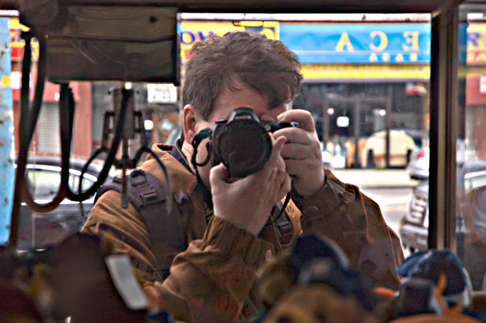 A reflected self-portrait, taken through an arcade game.
