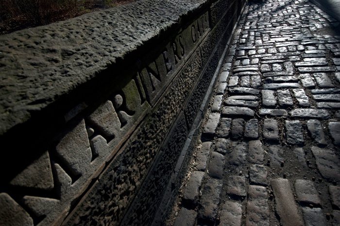 A gate into Central Park has its name chiseled in stone.