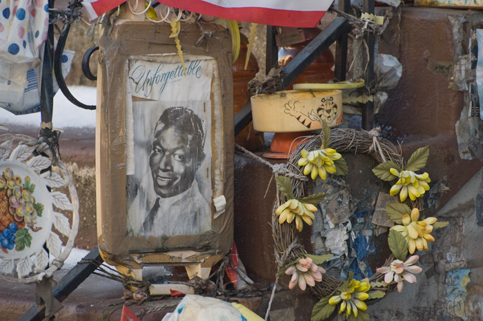 The stairs of a home have been decorated with an old photo of Nat King Cole, and a bowl with Tony the Tiger.