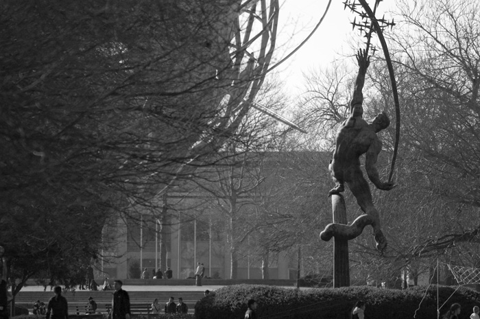 A symbolic statue hurls a rocket to the stars.