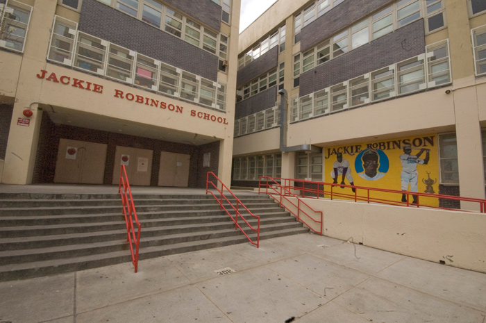 The entrance to a school named in honor of Jackie Robinson has a mural showing him batting and fielding.