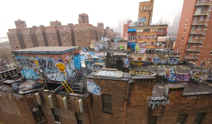 The tops of several buildings have been painted over with elaborate graffiti.