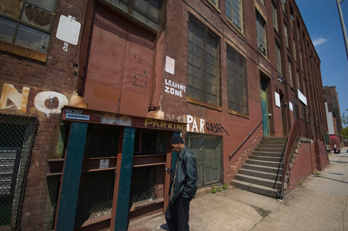 A man passes by a loading zone on a desolate street.