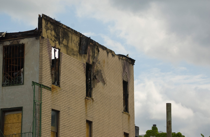 An apartment building, damaged by fire, is now an emprty shell.