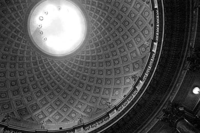 Light beams down from a domed ceiling with a diamond pattern.