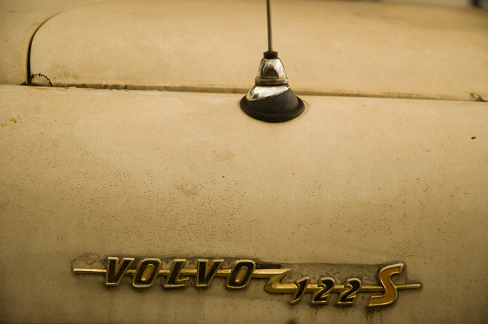 The front end of an old Volvo shows it sorely needs a new paint job, but the details remain.