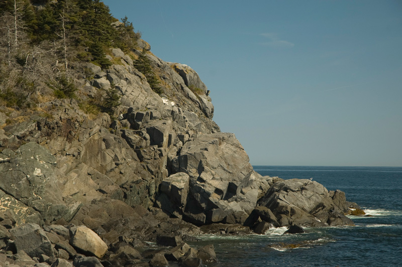 Rocky cliffs, surrounded by sea.