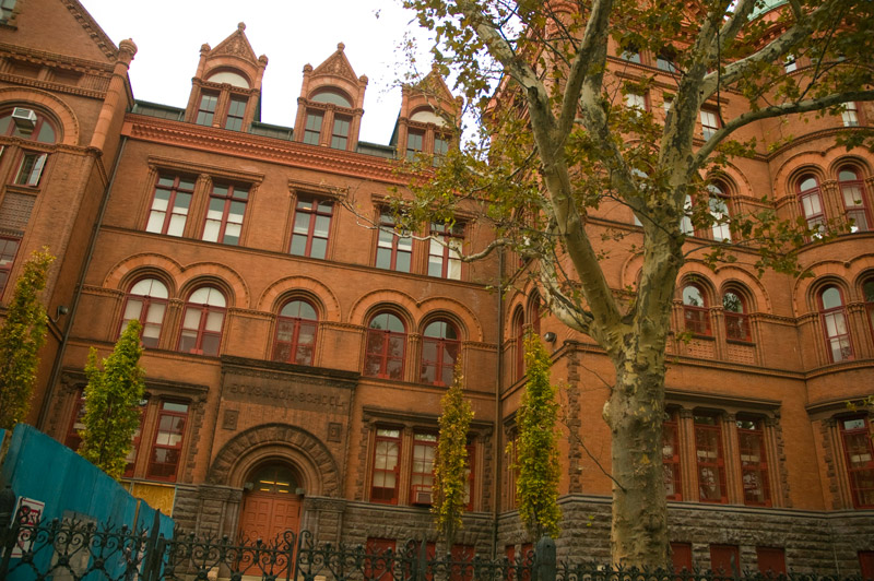 An ornate building with terra cotta details and arched windows.