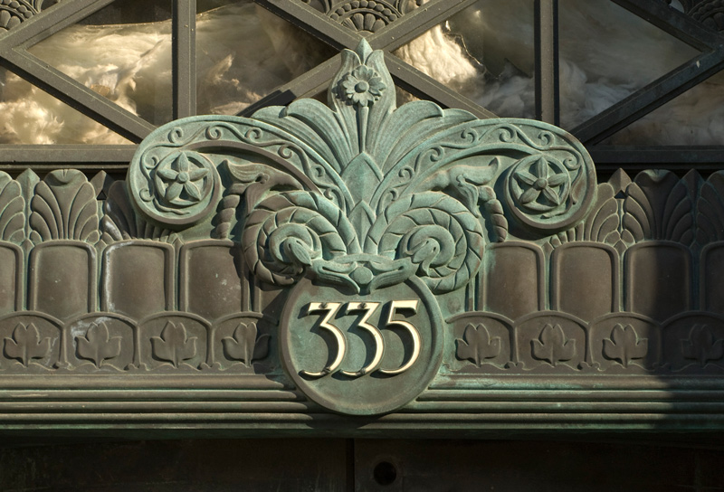 An ornate number over a door, marking the address.