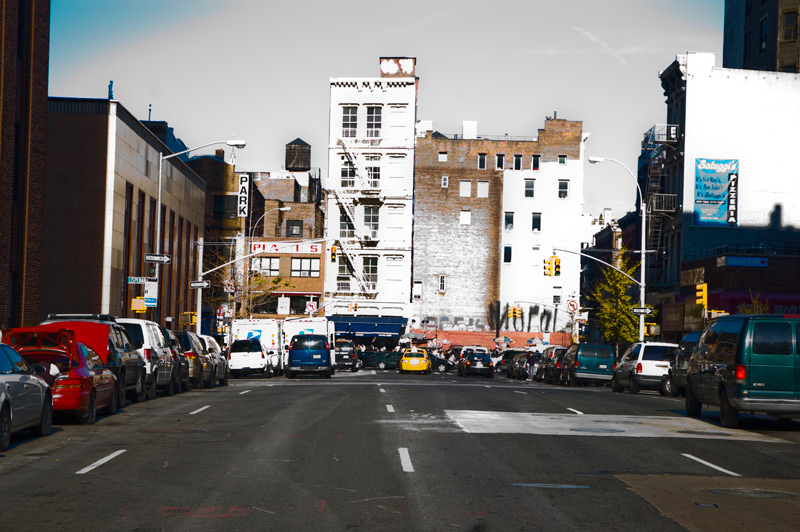 A street scene, overexposed and oversaturated.