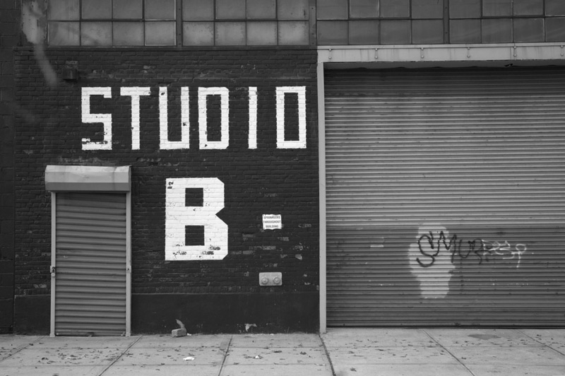 Imperfect block white letters on a black building read 'Studio B.'