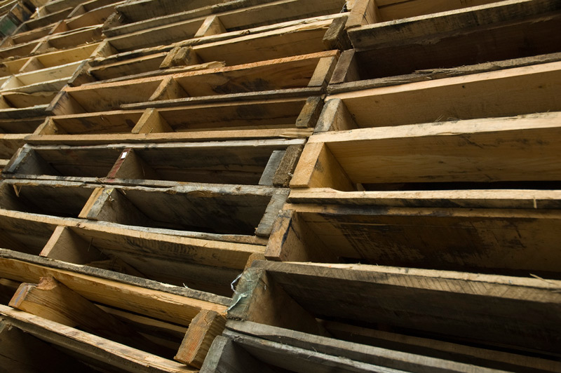 A huge stack of wooden shipping pallets