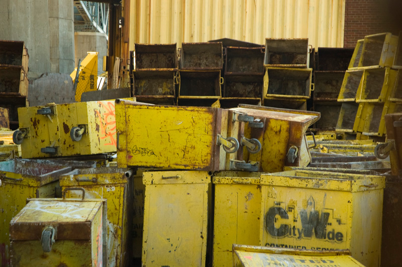 A collection of small yellow dumpsters.