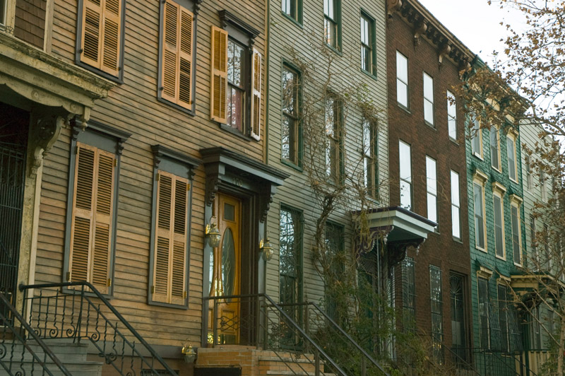 A row of short, wood frame houses.