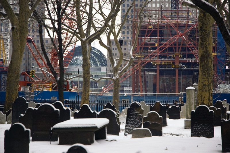 New construction towers over an 18th century graveyard.