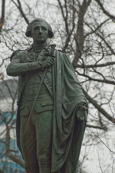 A statue of the marquis de Lafayette, among bare winter trees.