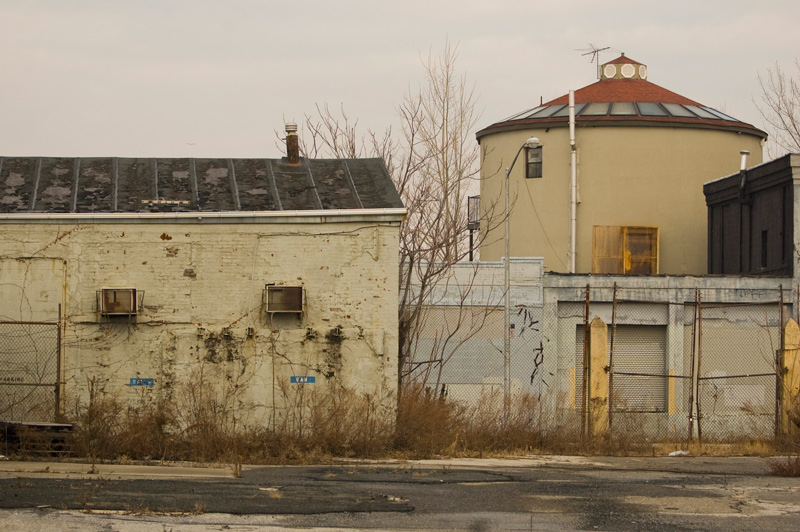 Buildings with peeling paint and exposed brick.